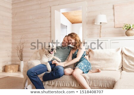 Stock fotó: A Nice Men On Sofa With Dog