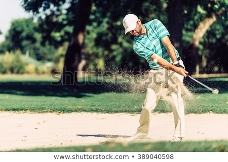 Foto stock: Golfer In Sand Trap