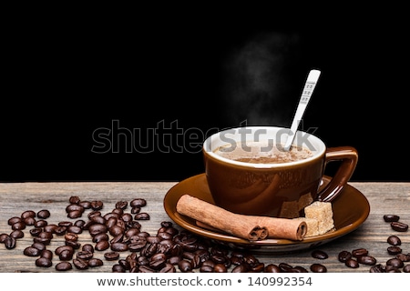 Stockfoto: A Cup Of Coffee And Cinnamon Coffee Beans Around It