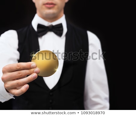 Stock fotó: Close Up Of Casino Dealer Holding Golden Coin