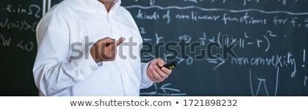 Stock photo: Senior Male Teacher Teaching Mathematics Writing On The Blackboard