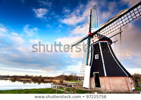 Stockfoto: Dutch Windmill Over River Waters