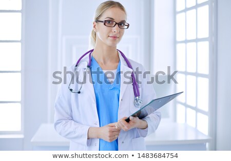 Stockfoto: Nurse And Doctor Looking In Folder In Hospital