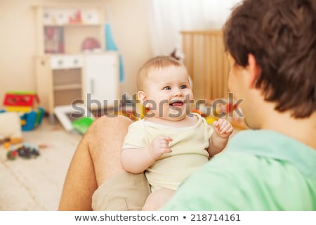 Stock photo: Father Holds Child On Hands In Playroom