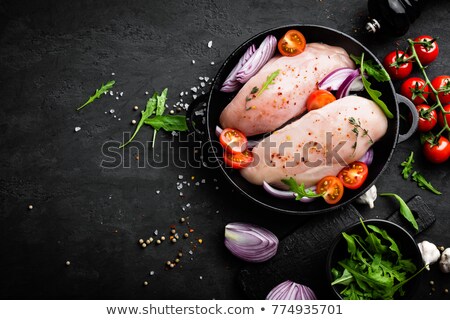 Foto stock: Fresh Raw Chicken Meat Fillet Marinated With Spices Onion And Tomatoes On Black Background Top Vi