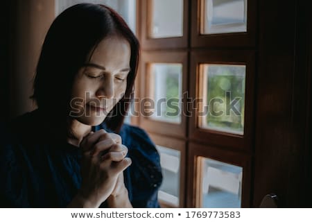 Foto d'archivio: Close Up Of Sad Woman Praying God In Church