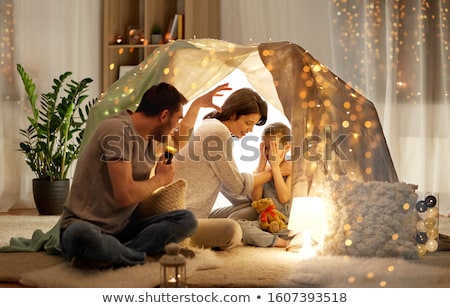 Foto stock: Father Telling Scary Stories To His Daughter