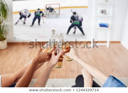 Foto stock: Friends Watching Ice Hockey And Drinking Beer