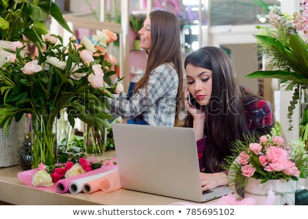 Stockfoto: Manager Of Flower Shop Talking Order By Phone