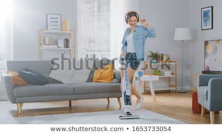 Foto stock: Woman Or Housewife With Vacuum Cleaner At Home