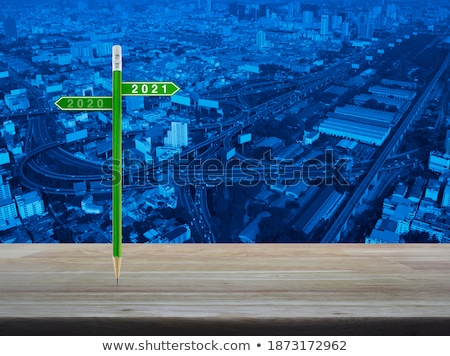 Foto stock: Street Sign Plate On Green Over Skyscrapers