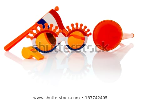 Stockfoto: Plastic Glasses Horn Flute And Flag In Orange Color