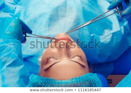 Stok fotoğraf: Hands With Plastic Surgery Tools Near Young Woman Face