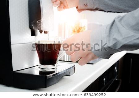 Foto stock: Man Making Black Coffee In Glass With Coffee Machine