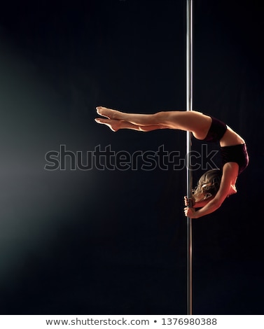 Foto stock: Young Slim Pole Dance Woman Exercising Over Dark