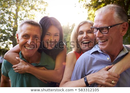 Сток-фото: Woman Talks With Mature Couple In Garden