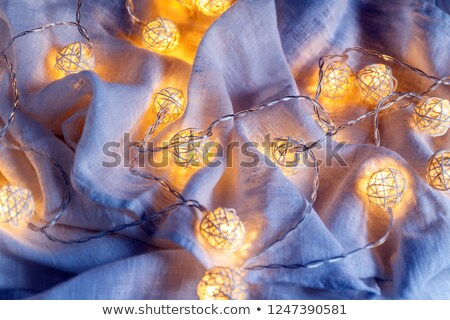 Stock photo: Background Of Garlands With Lights On The Folds Of Fabric In Blu