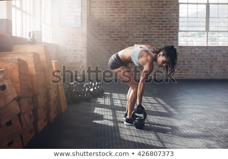 Foto d'archivio: Young Adult Fitness Woman Doing Swing Exercise With A Kettlebell