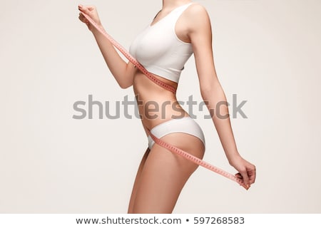 [[stock_photo]]: Close Up Of Woman Body With Measure Tape On Waist