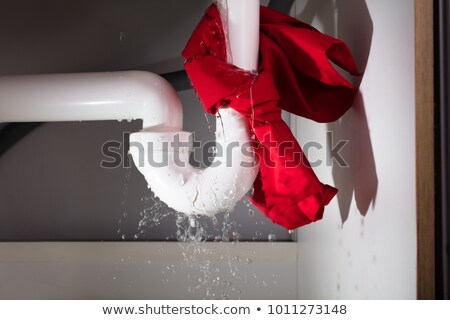 Stock fotó: Red Napkin Tied Under The Leakage Sink Pipe