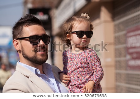 Foto stock: Young Father On Street With Tiny Daughter Girl