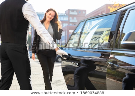 Stok fotoğraf: Chauffeur Opening Door For Businesswoman