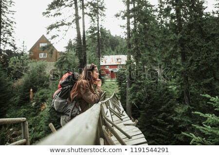 [[stock_photo]]: Young Girl Stands On Footbridge With Closed Eyes