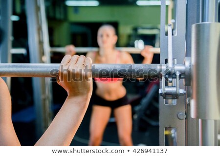 Foto stock: Smiling Woman With Barbells Focus Is On The Face Of The Girl