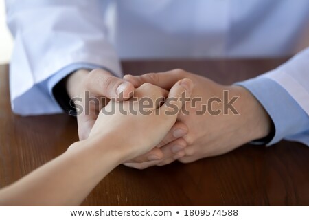 Stockfoto: General Practitioner And Caregiver Sitting At A Table