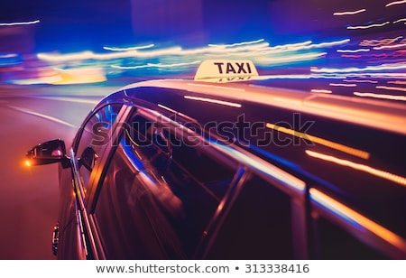 Сток-фото: Taxi Taking A Left Turn At Night