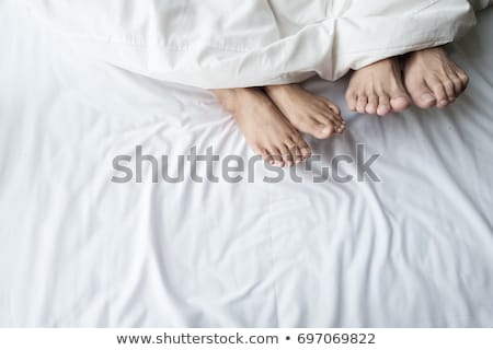 Stockfoto: Young Woman Sleeping Under A Quilt