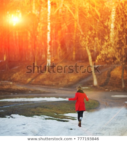 Stockfoto: A Nice Woman Running In Snowy Park