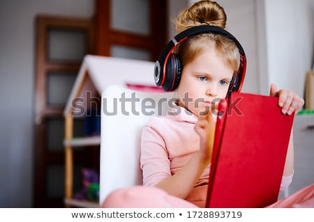 Foto d'archivio: Little Kid Using On Tablet With Educational Concept