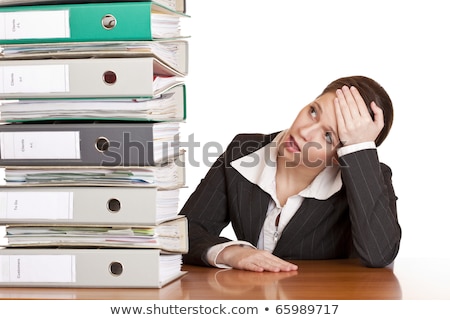 Foto stock: Business Woman In Office Looks At Unbelievable Folder Stack