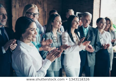 Сток-фото: Close Up Of A Woman Smiling With Business People Applauding While Watching Her Against White Backgro