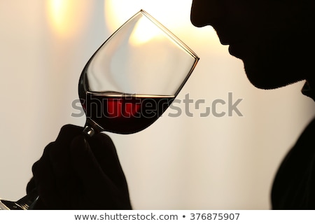 Foto stock: Thirsty Man Drinking Out Of A Wine Glass