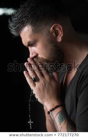 Foto stock: Handsome Young Man Praying In A Church