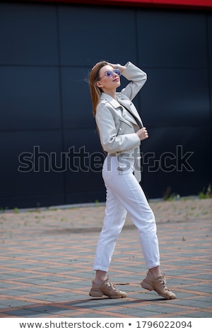 Stock fotó: Cute Smiling Girl In Gray Blouse And Jeans Isolated On White