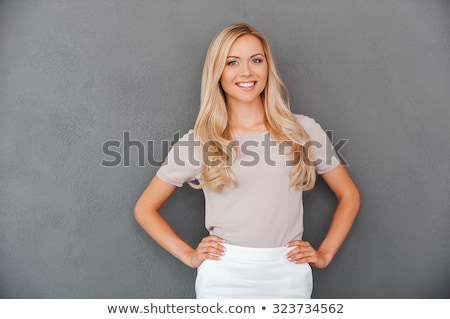 Stok fotoğraf: Smiling Businesswoman Standing With Her Hand On Hip