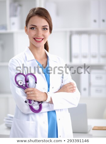 Сток-фото: Attractive Caucasian Brunette Female Smiling Doctor Standing In Office Smiling Holding Stethoscope W