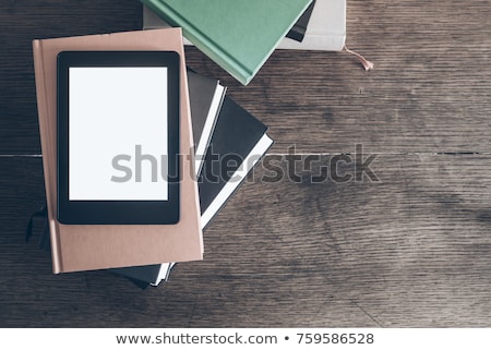 ストックフォト: E Book Reader With A Stack Of Books