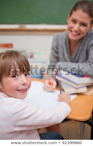 Сток-фото: Portrait Of Teacher Helping Young Student With Her Studies In Co