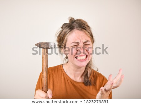 [[stock_photo]]: An Angry Female Construction Worker With A Hammer