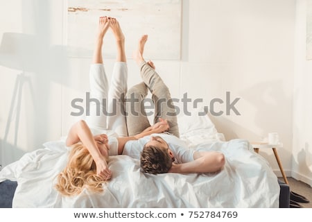 Foto d'archivio: Young Man And Woman In Bed Couple