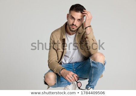 Stock fotó: Crouched Bearded Man With Hand In Hair