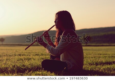 Stok fotoğraf: Indian With Flute At Sunset