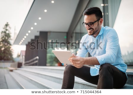 Stok fotoğraf: Cheerful Businessman Using Tablet Computer