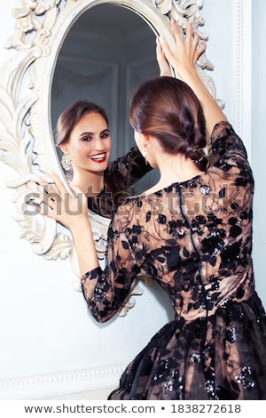 Foto d'archivio: Young Pretty Brunette Girl In Fashion Dress On Sofa Posing In Luxury Rich Home Interior Lifestyle M