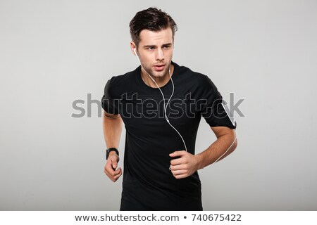 Stock foto: Portrait Of A Healthy Sportsman Listening To Music While Running