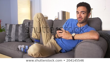 Stock fotó: Young Attractive Mexican Man At Home Sitting On Couch